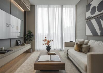 Modern living room with large sofa, coffee table, and floor-to-ceiling windows