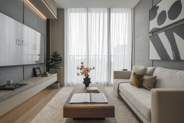 Modern living room with large sofa, coffee table, and floor-to-ceiling windows