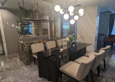 Modern dining room with chandelier and marble accents