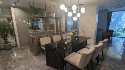 Modern dining room with chandelier and marble accents