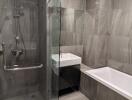 Modern bathroom with glass shower, bathtub, sink, and toilet