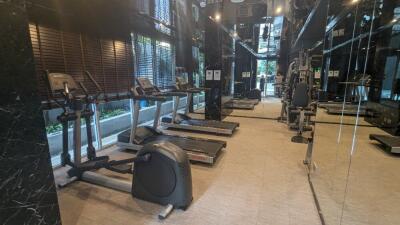 Modern gym with exercise equipment and large mirrors