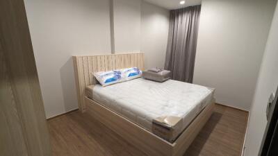 Cozy bedroom with wooden flooring and bedframe