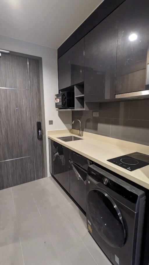 Modern kitchen with dark cabinets and built-in appliances