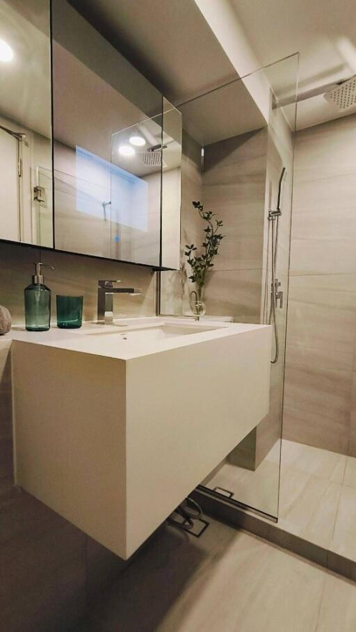 Modern bathroom with glass shower and floating vanity