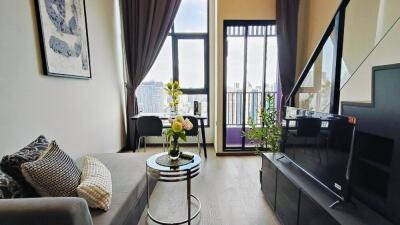 Modern living room with large windows and balcony