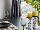 Dining area with a well-set table and a window view