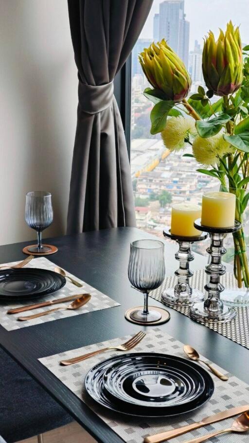 Dining area with a well-set table and a window view