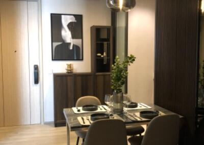 Modern dining room with a small table and chairs by a wooden cabinet