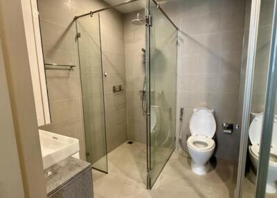 Modern bathroom with glass shower enclosure and toilet