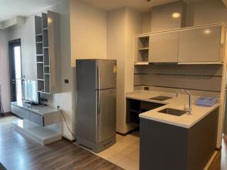 Modern kitchen with built-in cabinets and adjoining living area