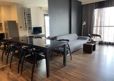 Modern living room with dining area and natural light