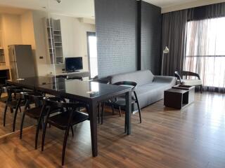 Modern living room with dining area and natural light