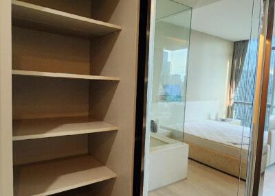 Bedroom with open closet and large mirror