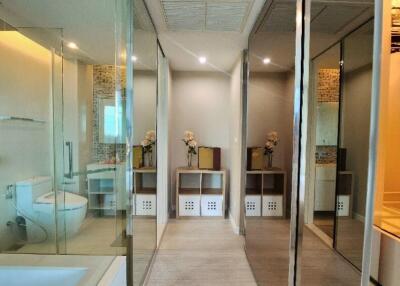 Modern bathroom with glass partitions and decorative elements