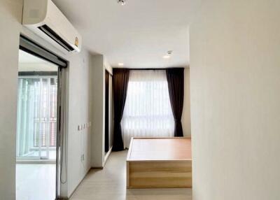 Bedroom with a window, curtain, and air conditioner