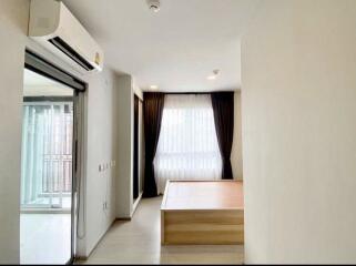 Bedroom with a window, curtain, and air conditioner