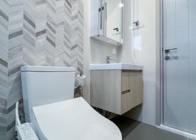 Modern bathroom with white fixtures and wall-mounted vanity