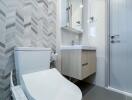 Modern bathroom with white fixtures and wall-mounted vanity