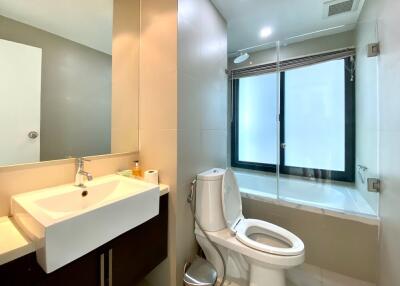 Modern bathroom with sink, toilet, and walk-in shower