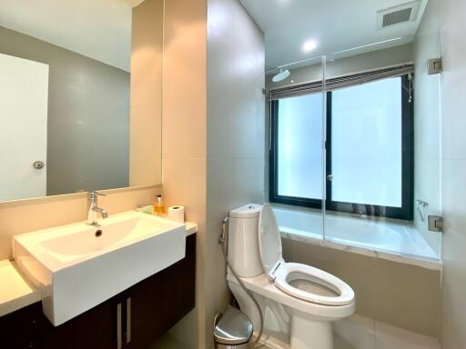 Modern bathroom with sink, toilet, and walk-in shower