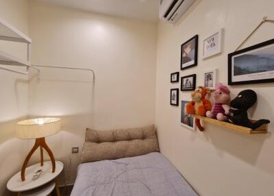 Cozy bedroom with wall-mounted shelf and stuffed animals