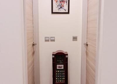 Hallway with a wall painting and a decorative piece