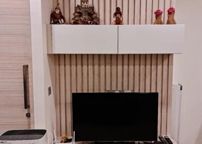 A modern living room TV setup with decorative items