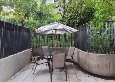 Outdoor patio with table, chairs, and umbrella