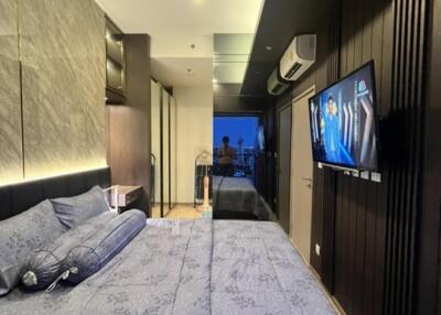 Modern bedroom with stylish decor and a wall-mounted TV