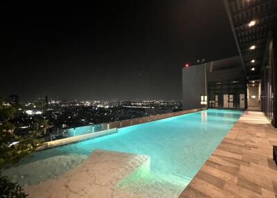 Night view of a rooftop infinity swimming pool