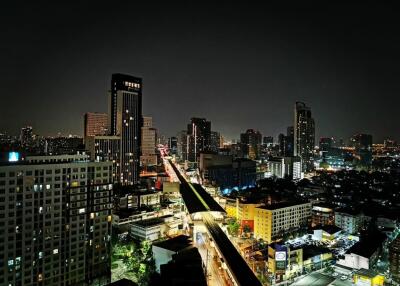 Night view of city skyline with illuminated buildings and roads