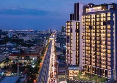 Exterior view of a tall modern apartment building in a city at dusk