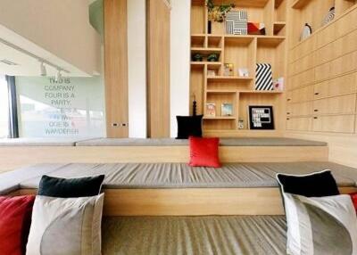 Modern living room with built-in wooden shelves and seating