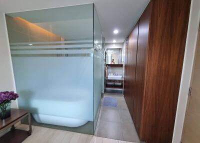 Modern bathroom with frosted glass shower and wooden paneling