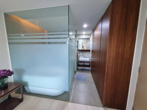 Modern bathroom with frosted glass shower and wooden paneling