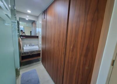 Modern bathroom with wooden cabinets and glass shower