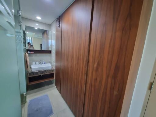 Modern bathroom with wooden cabinets and glass shower