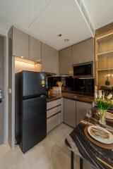 Modern kitchen with black appliances and dining setup