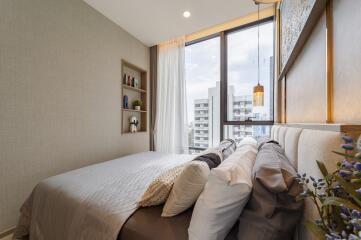 Modern bedroom with large windows and city view