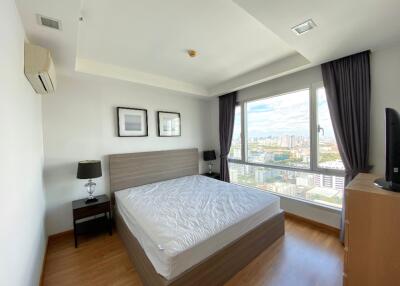 Modern bedroom with large window and city view