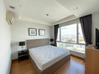 Modern bedroom with large window and city view