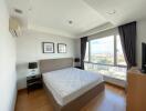 Modern bedroom with large window and city view