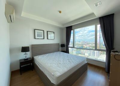 Modern bedroom with large window and city view