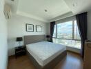 Modern bedroom with large window and city view