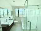 Modern bathroom with large window and city view