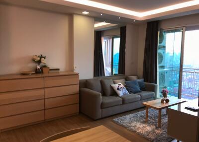 Modern living room with sofa, coffee table, and balcony view