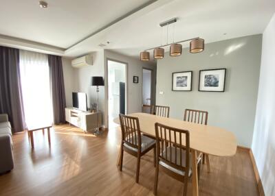 Modern living room with dining area and natural light