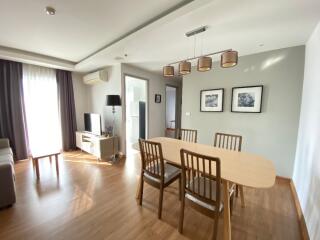 Modern living room with dining area and natural light