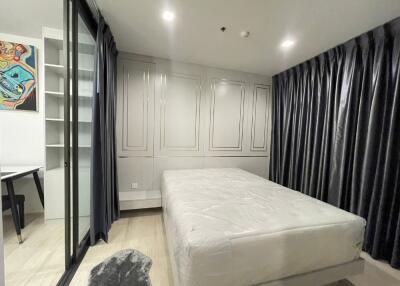 Modern bedroom with large bed and ample storage